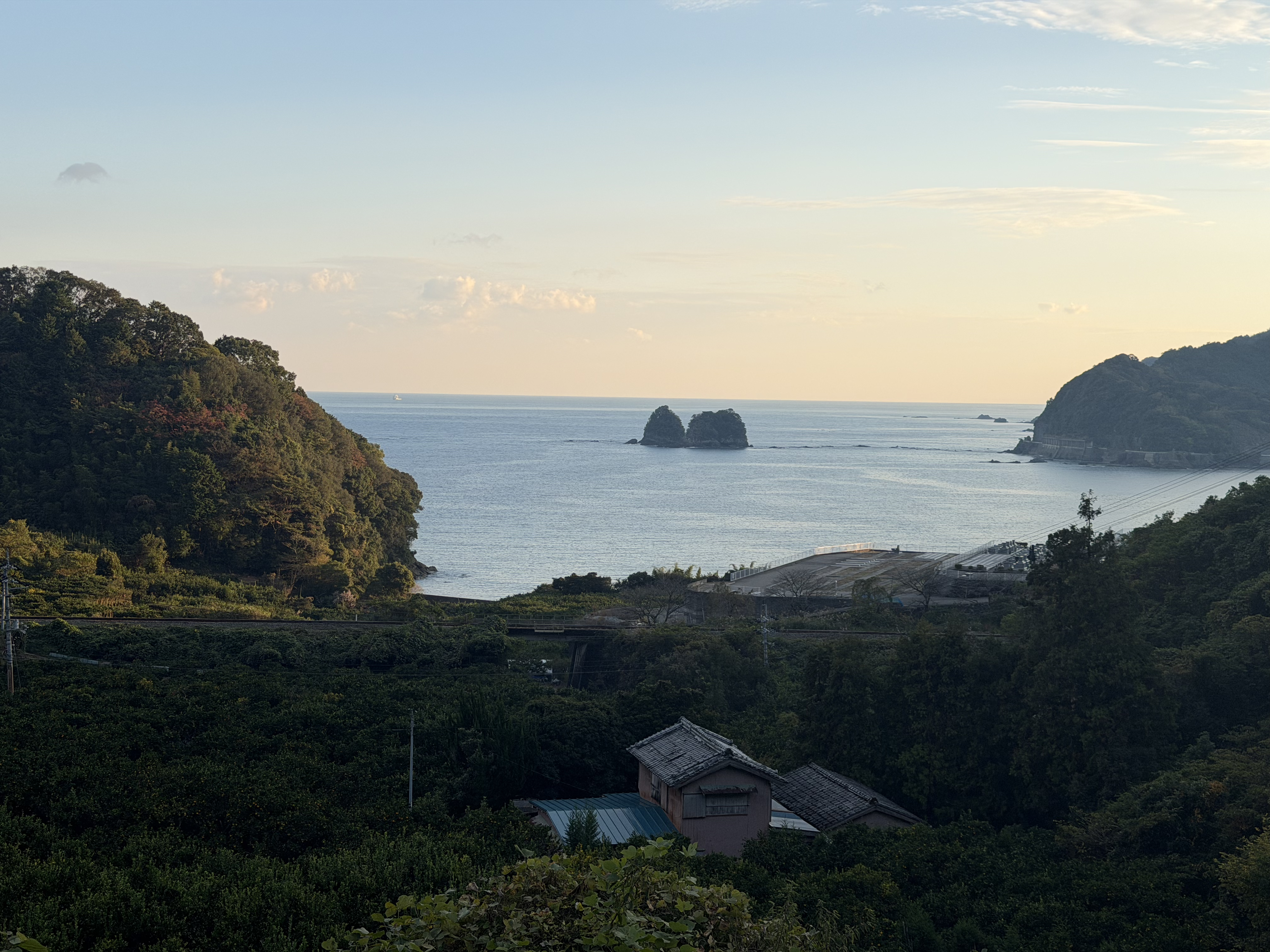 Evening coastal vista with a rocky islet and headlands